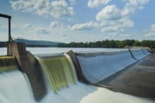 A large water dam representing that Petrotech, which is based in Houston, TX, won a contract to upgrade the control systems of 13 hydroelectric facilities
