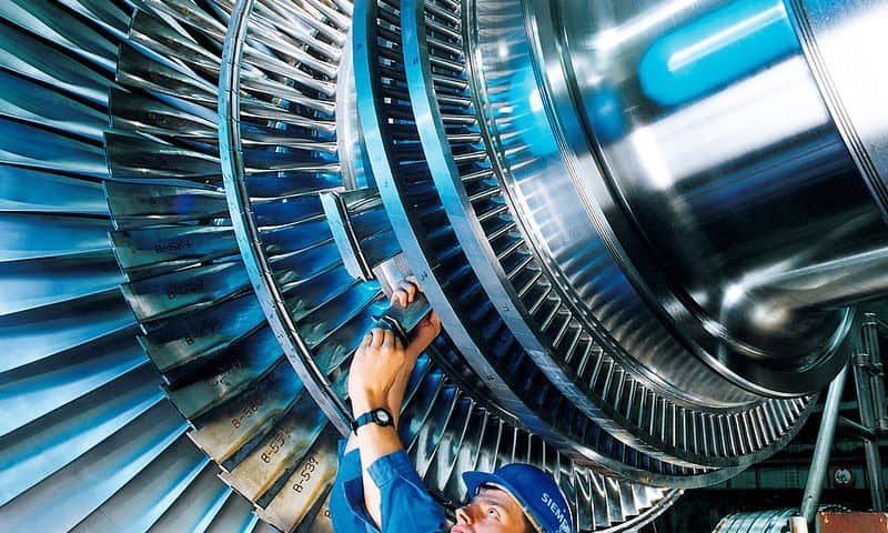 A man working on a steam turbine