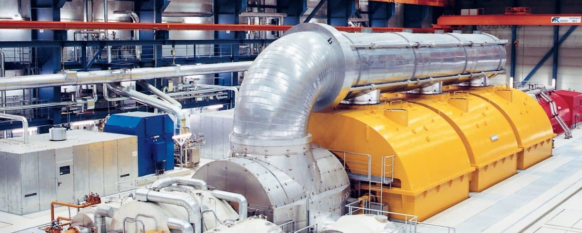 A yellow and silver turbine control system representing the use of governor in a steam turbine as explained by Petrotech, which has a location in New Orleans, LA